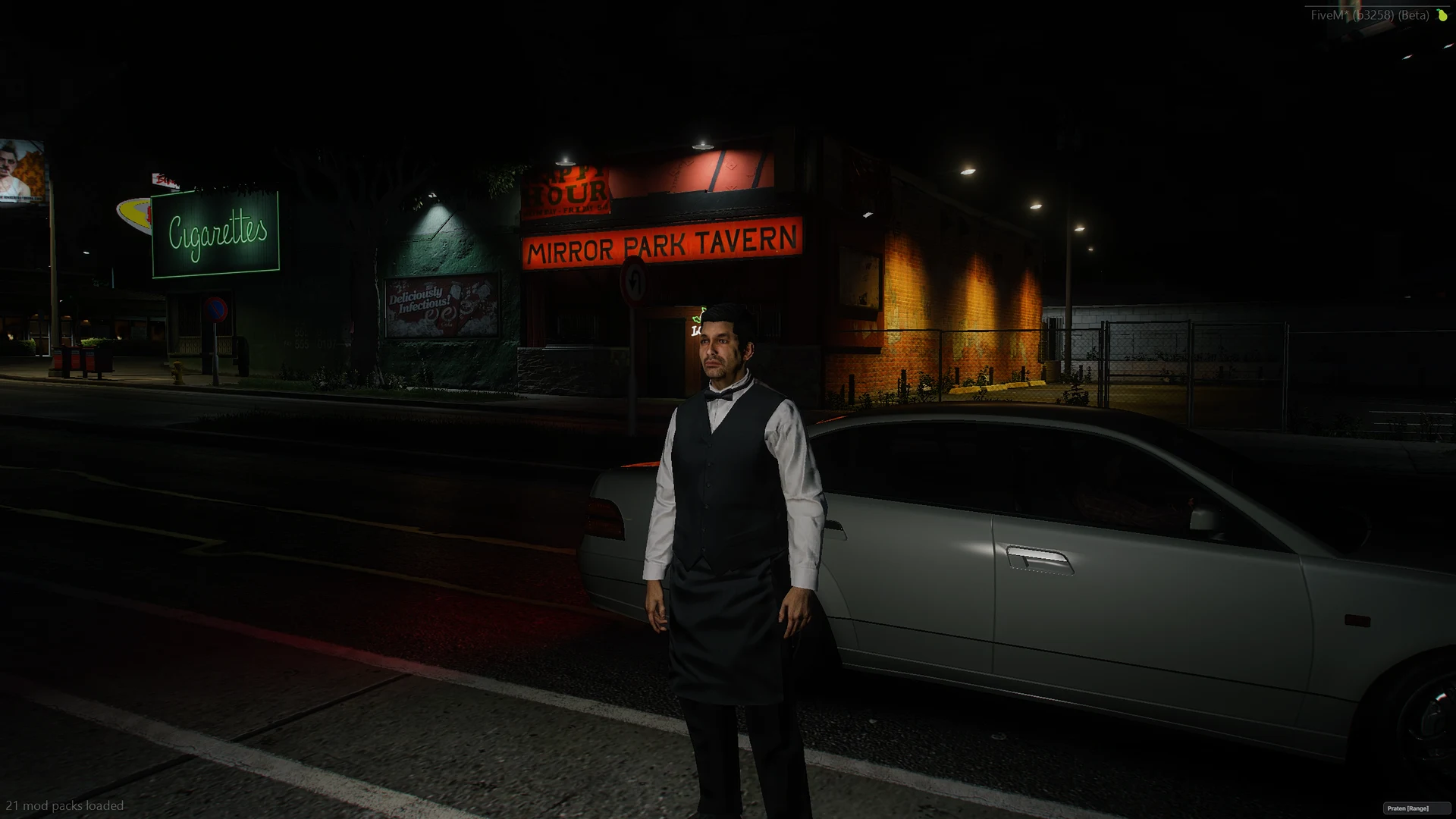 Bar staff in work clothes on the pavement late at night.